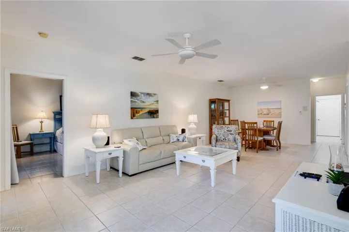 Living room featuring a ceiling fan and light tile patterned flooring