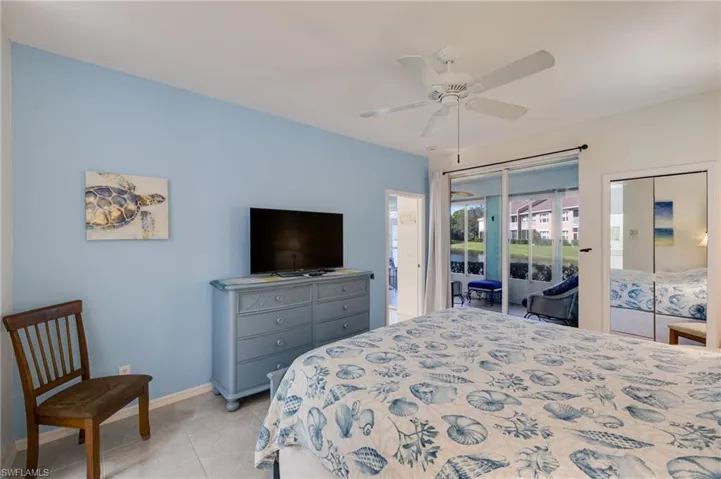 Bedroom with access to exterior, ceiling fan, and light tile patterned floors