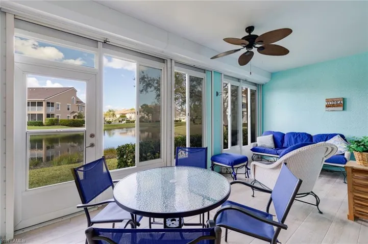 Sunroom with ceiling fan, outdoor lounge area, and a water view