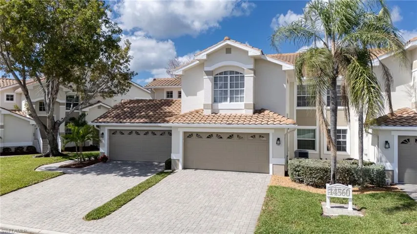Mediterranean / spanish-style home featuring decorative driveway, stucco siding, and a tiled roof
