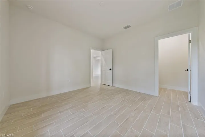 Unfurnished room featuring wood tiled floors
