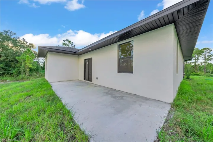 Rear view of property featuring a patio area and stucco siding