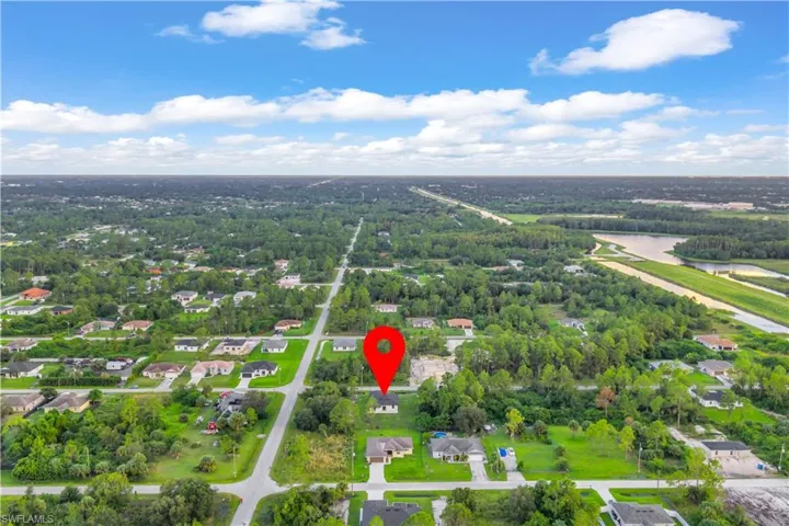 Aerial view of residential area featuring a large body of water
