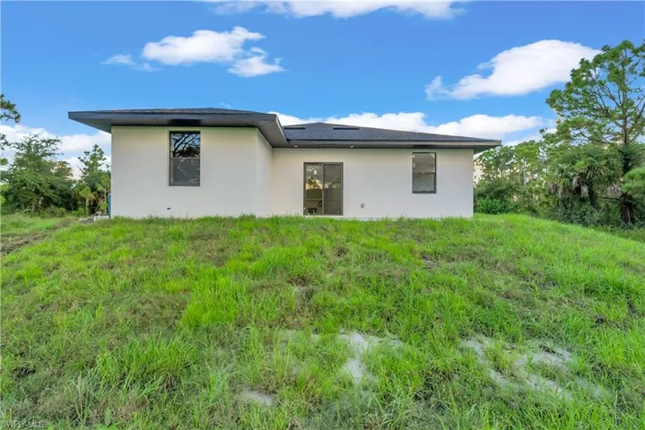 Rear view of property featuring stucco siding