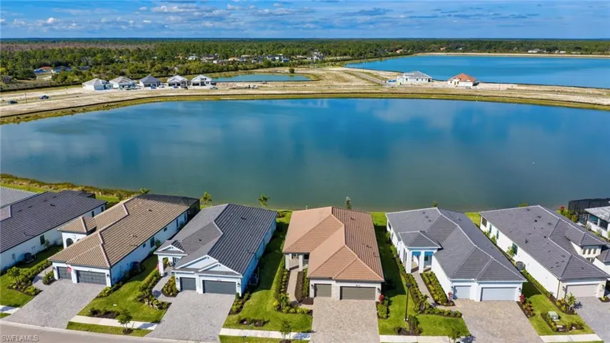 Aerial perspective of suburban area featuring a large body of water