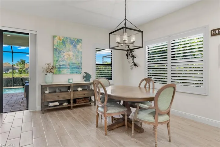 Dining area with light hardwood / wood-style flooring and a chandelier