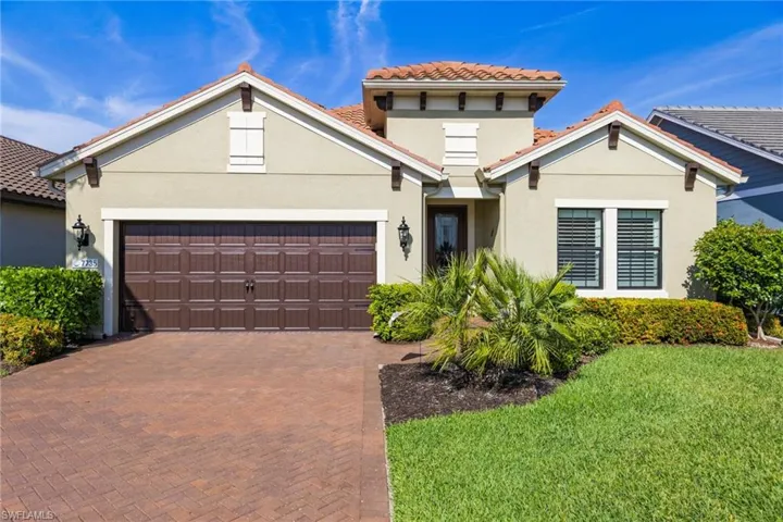 View of front facade with a garage and a front lawn