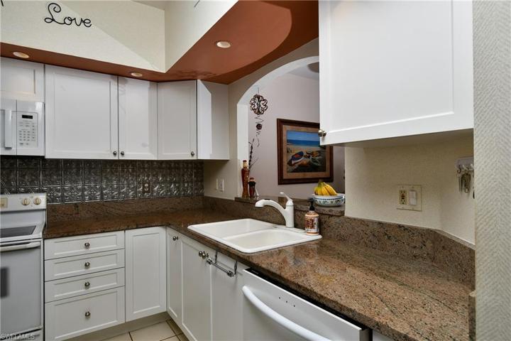 Kitchen is efficiently laid out and has been updated with resurfaced cabinets and granite countertops.