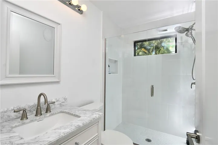 Bathroom with a shower stall and vanity