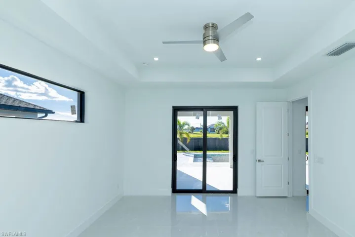 Spare room with ceiling fan and a raised ceiling
