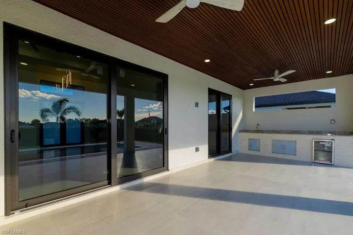 View of patio / terrace featuring ceiling fan and beverage cooler
