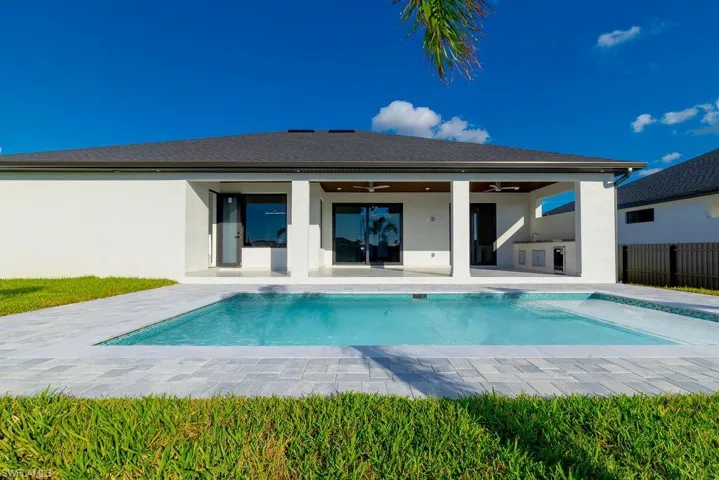 View of pool featuring a patio area and ceiling fan