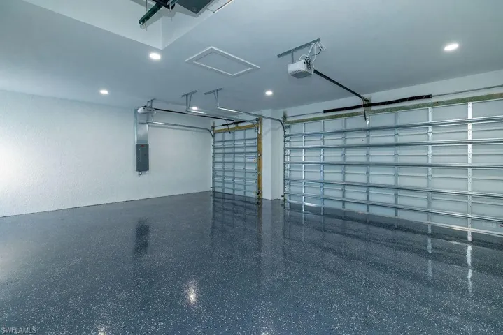 Garage with a garage door opener and electric panel