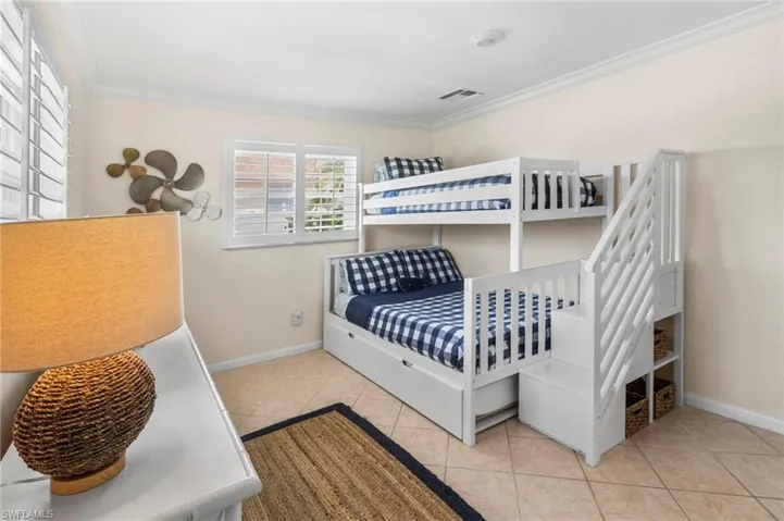Bedroom featuring ornamental molding and light tile patterned floors