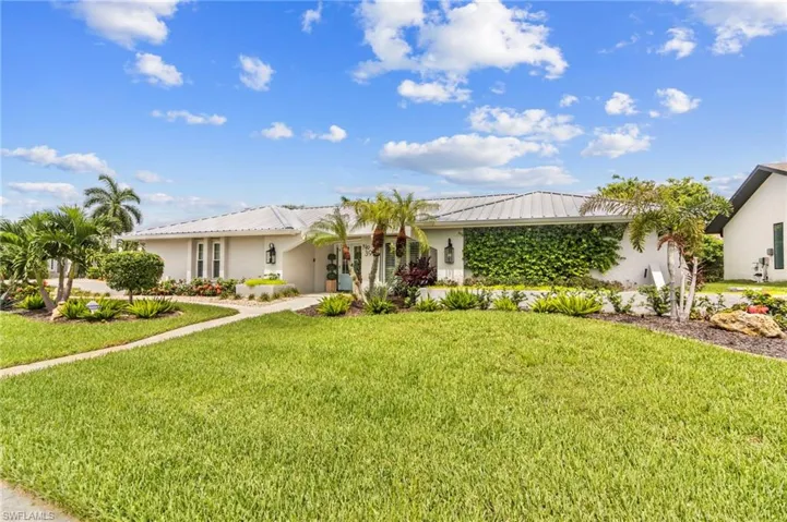 Ranch-style house featuring a front lawn