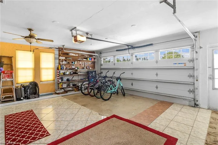 Garage with a garage door opener and ceiling fan