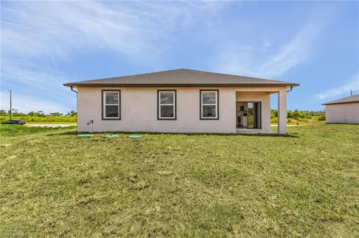 Back of house featuring a yard