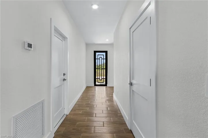 Corridor featuring dark hardwood / wood-style floors