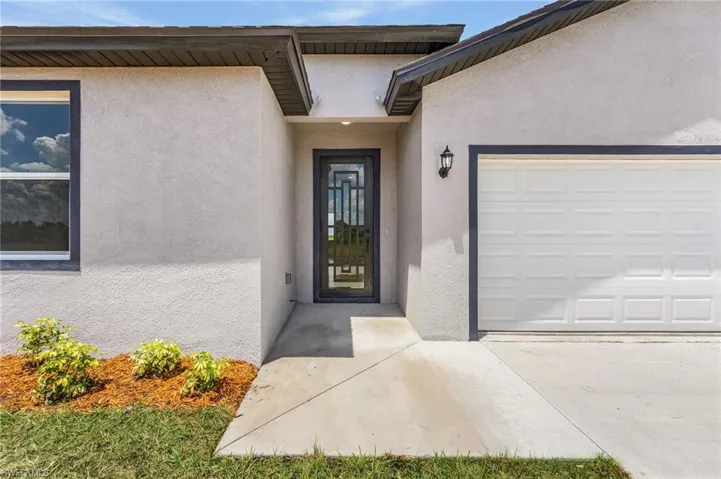 View of exterior entry featuring a garage