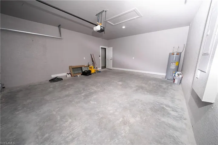 Garage with electric water heater and a garage door opener