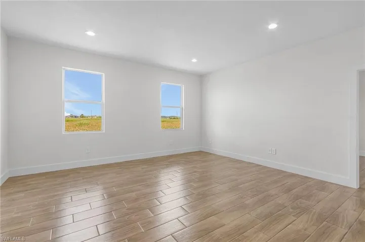 Empty room featuring light hardwood / wood-style flooring and plenty of natural light