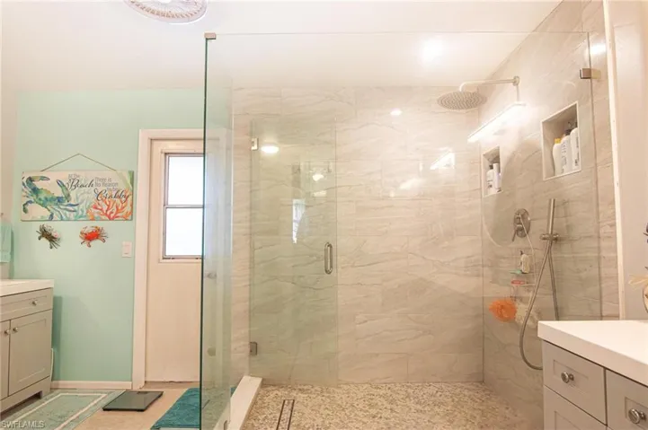 Main bathroom off the primary bedroom. Pool bath door. Huge walk in shower, 2 separate sinks/vanities.
