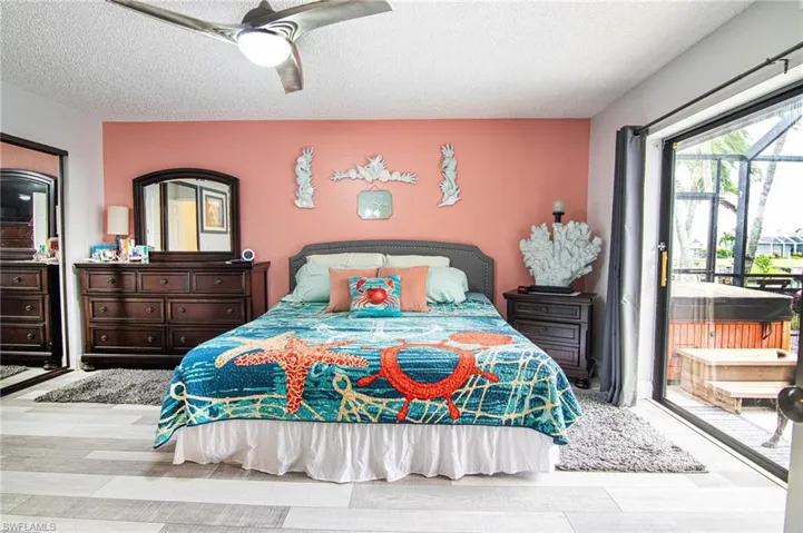 Primary bedroom. Slider out to the screened lanai. Two huge walk in closets.