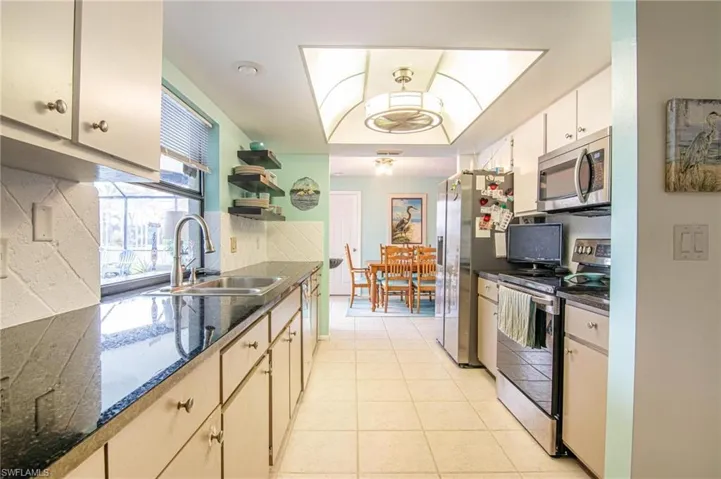 Kitchen has granite tops, pass-through to the lanai, stainless appliances.