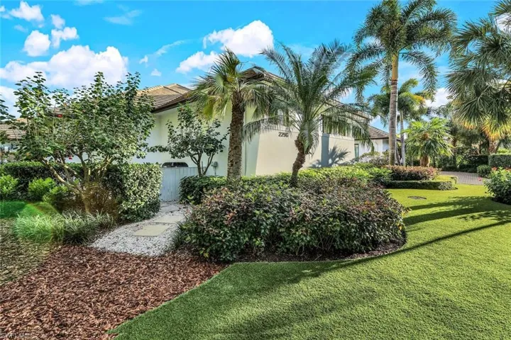 Side of home leading to generator complete with high-end artificial turf for easy maintenance.