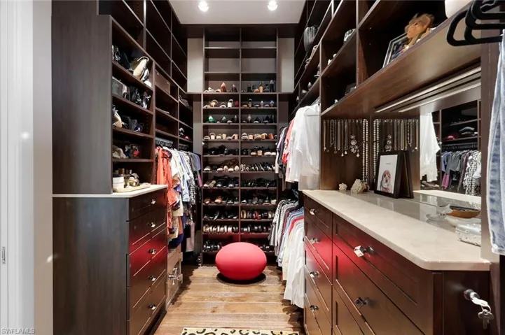 First walk-in closet with automatic lighting.