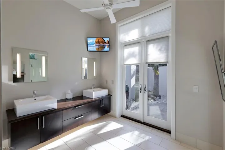 Primary bathroom with walkout to private, outdoor shower.