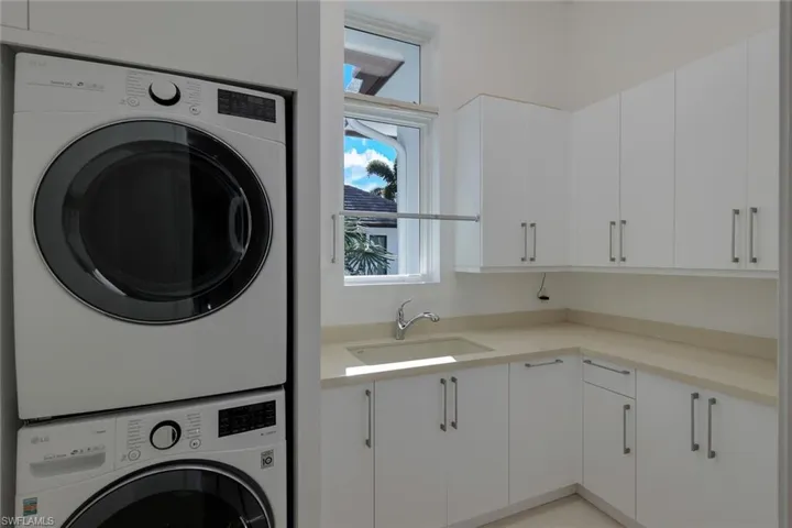 Laundry room with new cabinets and washer/dryer