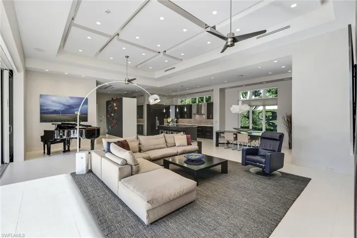Living area with view into the kitchen and dining area.