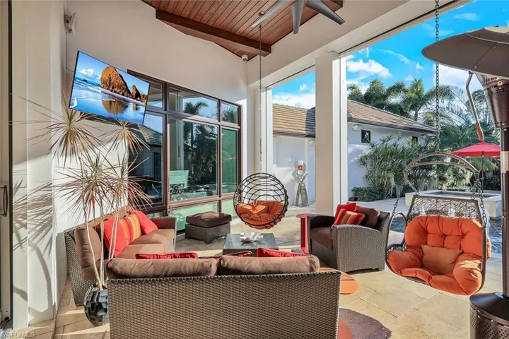 Covered lanai with outdoor tv and automated screens and shutters.
