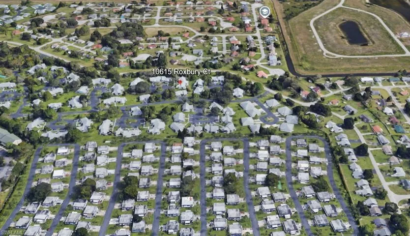 Aerial view of property's location featuring nearby suburban area