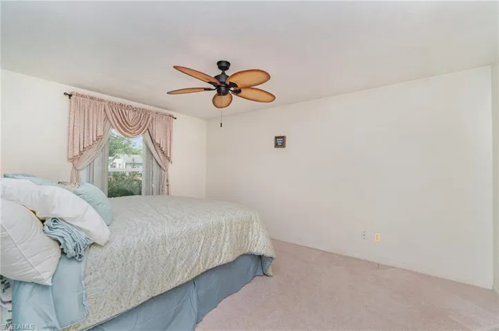 Bedroom with carpet flooring and a ceiling fan