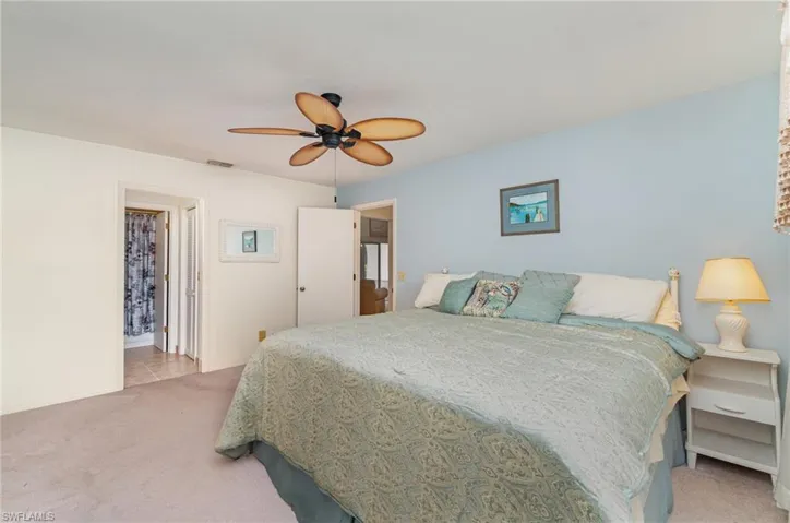 Bedroom with light colored carpet and ceiling fan
