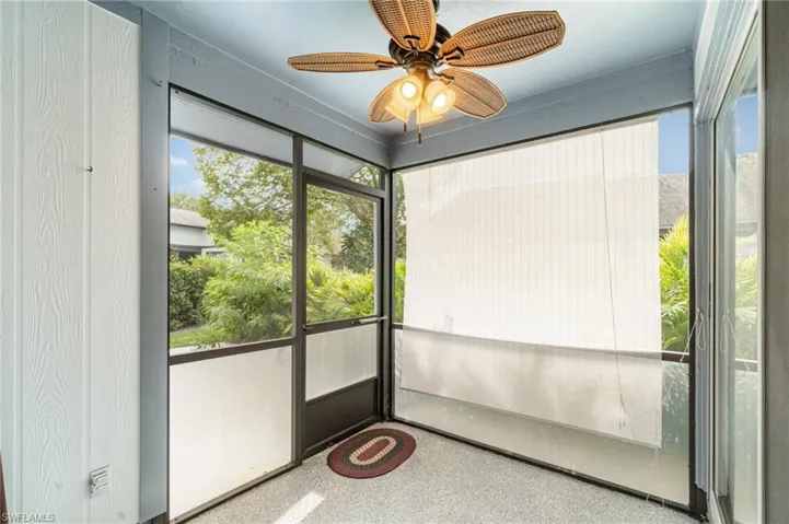 Unfurnished sunroom featuring a ceiling fan