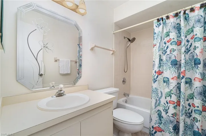 Bathroom with shower / tub combo and vanity