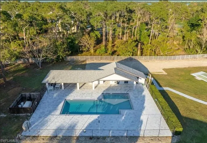 Aerial view of property and surrounding area with a pool area