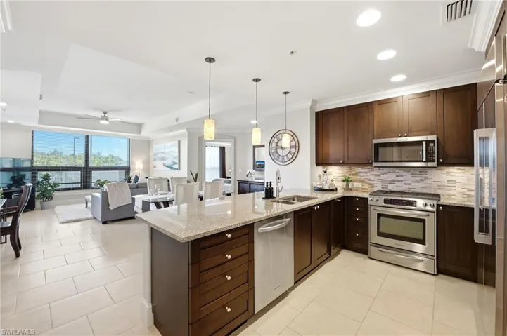 Sophisticated Kitchen with light color tile complimenting the dark cabinetry