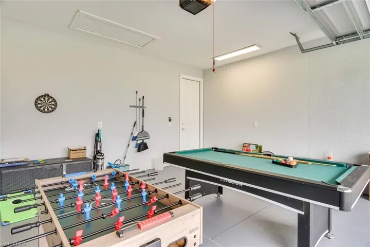 Playroom featuring billiards and concrete flooring