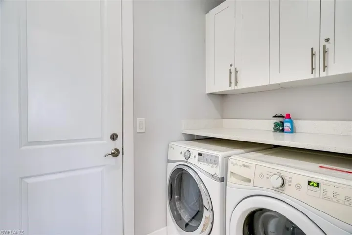 Laundry room with cabinets and independent washer and dryer