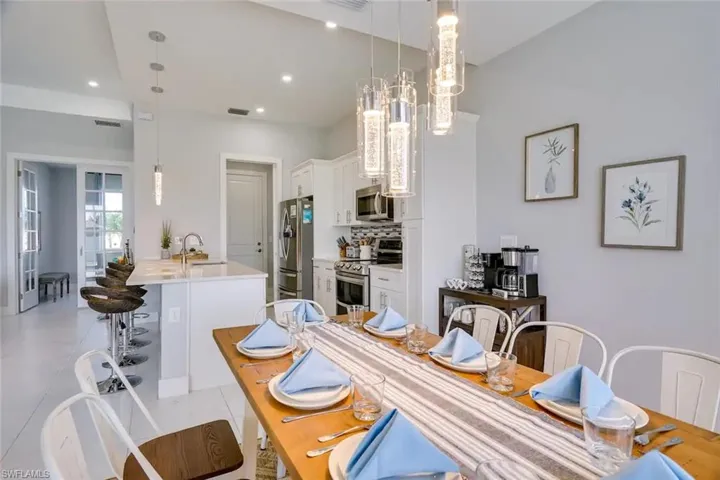 Dining space featuring light tile patterned floors and sink