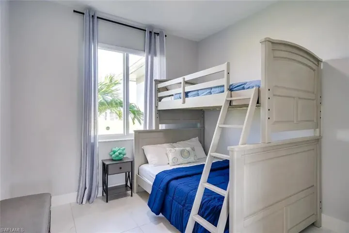 Bedroom with light tile patterned flooring
