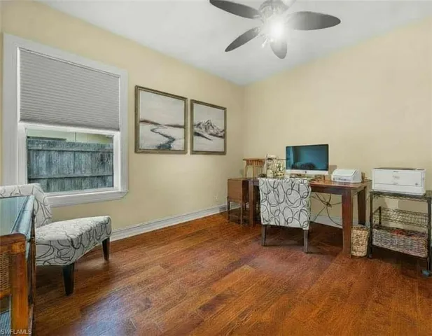 Office with wood finished floors and ceiling fan