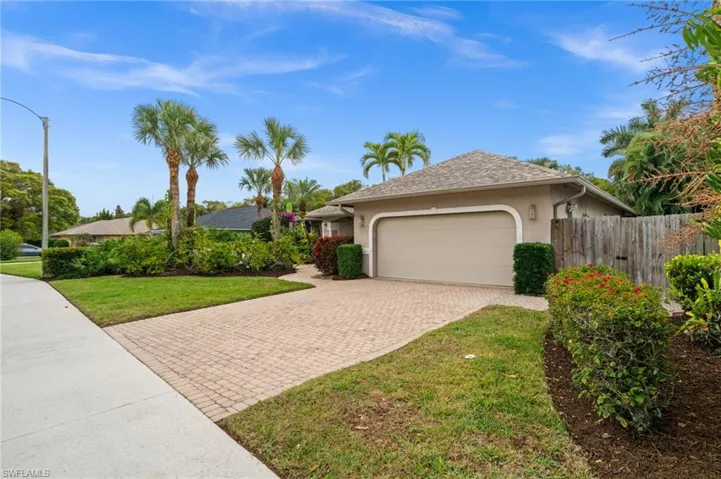Ranch-style house with stucco siding, decorative driveway, and an attached garage