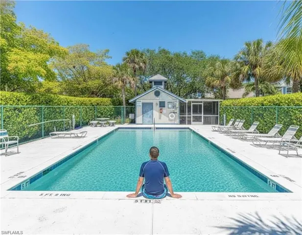 Community pool with a patio