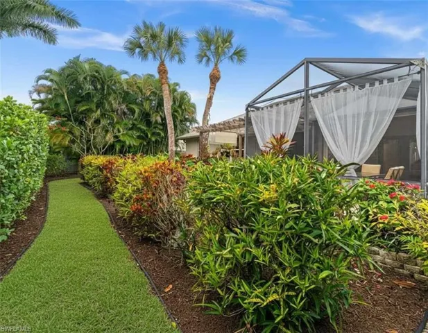 View of grassy yard with a lanai