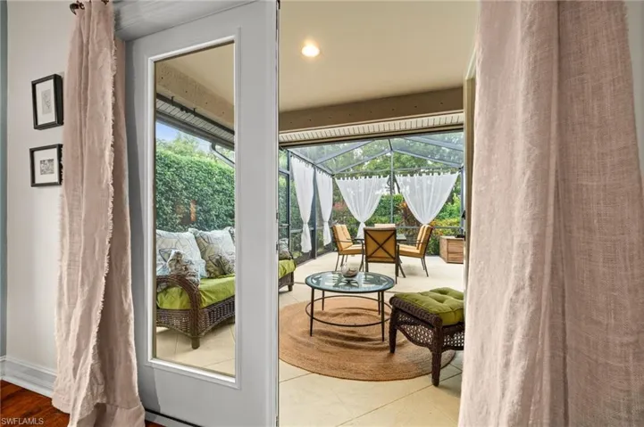 Doorway featuring a sunroom and tile patterned flooring